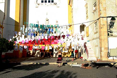 Image: Recycling clothe installation and paint clothe by the citizents of Avis at the main door of the church